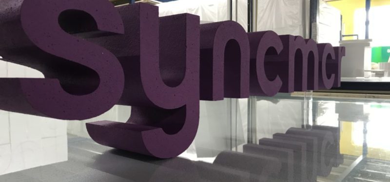 Syncmcr Painted Polystyrene lettering On A Clear Acrylic Pole